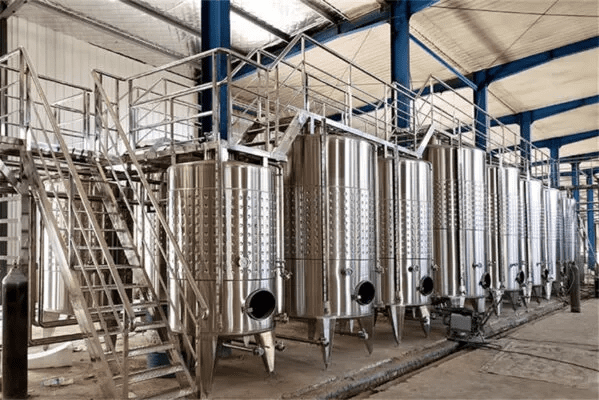 The 10000L Wine Fermentation Tank is a large-capacity, industrial-grade vessel designed for efficient fermentation and storage of red wine, white wine, and various fruit wines. Constructed from high-quality SUS304 or SUS316L stainless steel, it features a robust inner shell (typically 3.0 mm) and outer shell (2.0 mm), combined with 80–100 mm polyurethane insulation to ensure excellent temperature stability. Equipped with advanced glycol cooling jackets, it allows precise temperature control throughout the fermentation process. The tank is designed with a conical or flat bottom for flexible operation, and comes complete with essential accessories such as a top manway, CIP cleaning system, sampling valve, temperature probe, pressure relief valve, and adjustable legs. Its sanitary design, durability, and user-friendly configuration make it an ideal solution for commercial wineries seeking reliable and high-performance fermentation equipment.